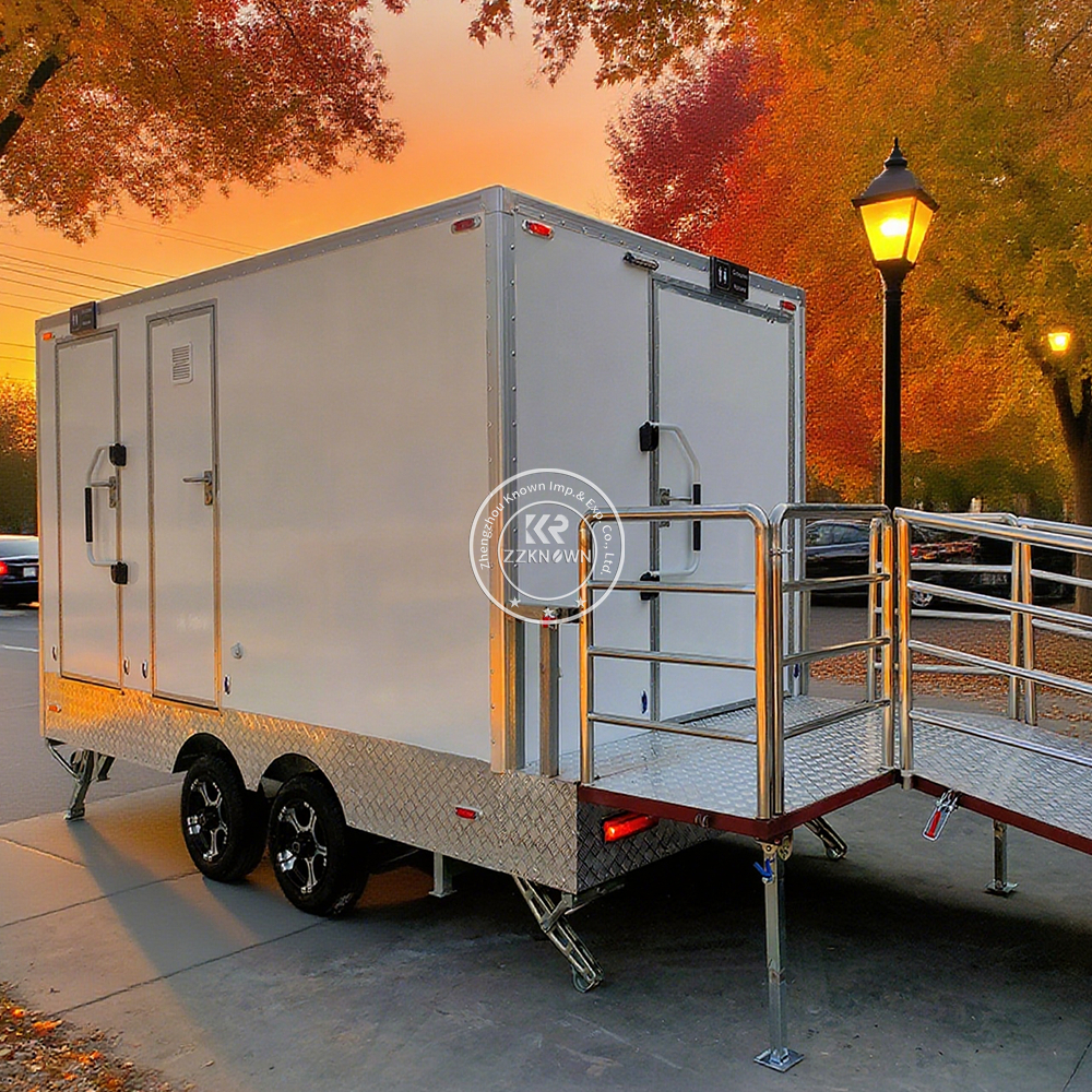 A-modern-white-4-meter-toilet-trailer-with-two-separate-entrances,-parked-outdoors,-showcasing-accessibility-friendly-design