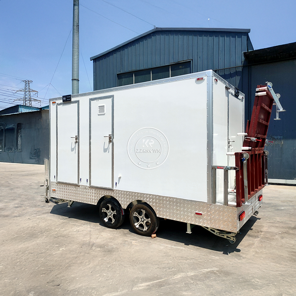 Side view of a white portable restroom trailer with foldable steps and stabilizing jacks