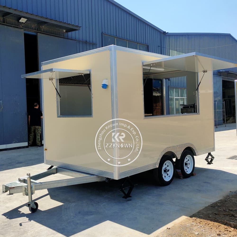 Sandwich trailer with custom branding and open sales window in use at a street festival